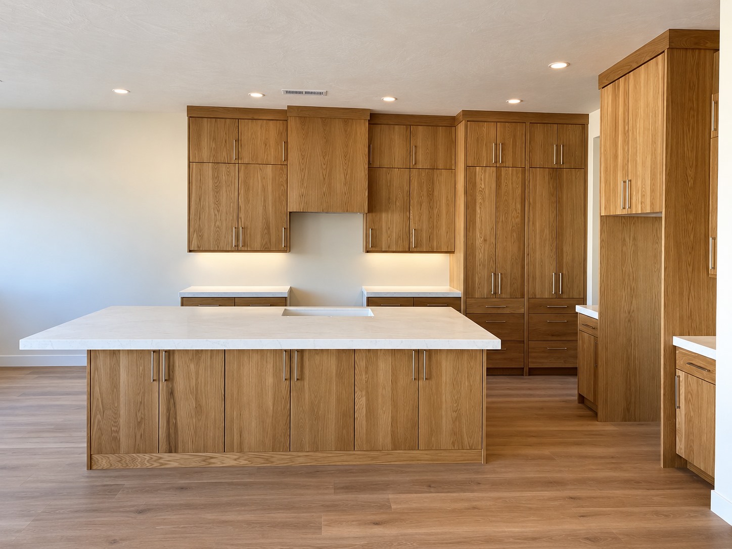 Warm oak kitchen with custom cabinetry built by Sharp Builders